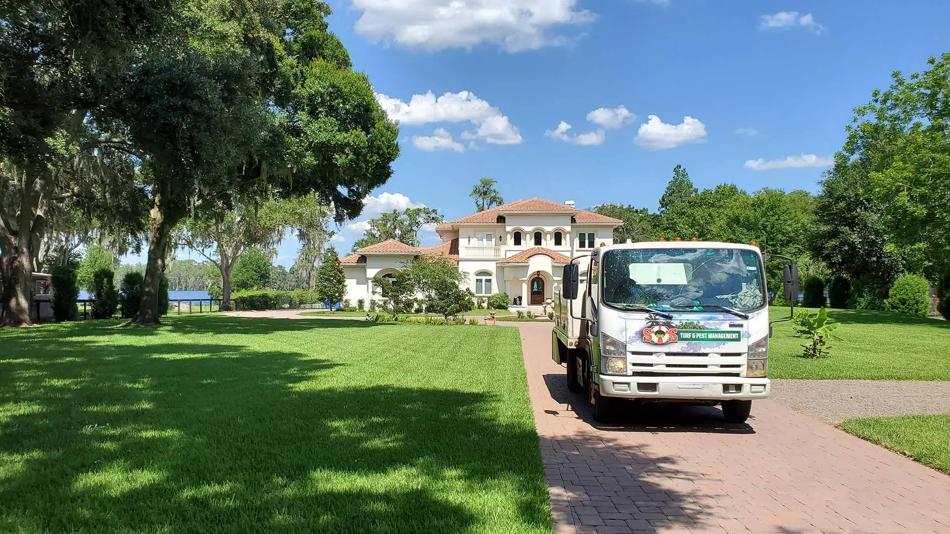 S.O.S. Turf & Pest servicing upscale residential home for lawn care.